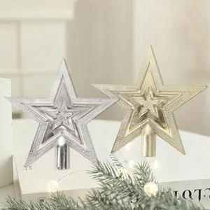 Gold and silver electroplated star Christmas tree toppers on a decorative background.