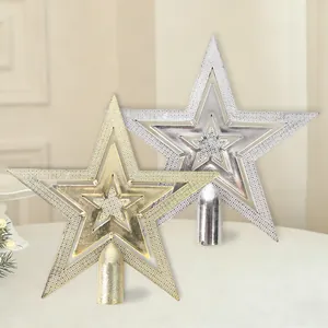 Macro view of gold and silver plated hollow-out Christmas tree top stars with textured surface