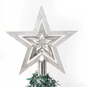 Close-up detail of a bright silver electroplated star tree topper on a Christmas tree.