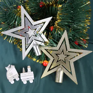 Detailed view of gold and silver electroplated five-pointed stars for Christmas tree tops.