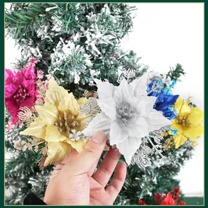 Glittery artificial Christmas poinsettia flowers in various colors for festive tree decoration