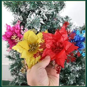 Macro detail of 16cm glitter artificial poinsettia flowers for Christmas tree decoration.
