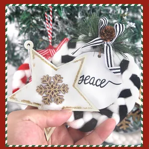 Close-up detail of Christmas wooden star ornament and plush wreath with Peace tag