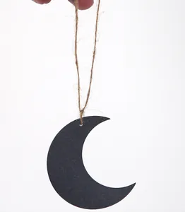 Detail view of black crescent moon wooden pendant for Middle Eastern festival decoration