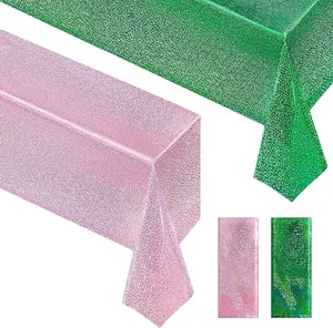 Macro view showing detailed texture of pink and green holographic glitter party tablecloth.