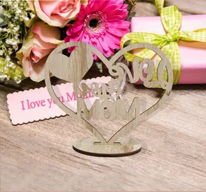 Close-up of a handcrafted wooden heart table ornament with 'Love you Mom' cutout