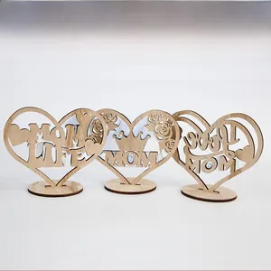 Close-up view of three laser-cut heart-shaped wooden Mother's Day tabletop decorations.