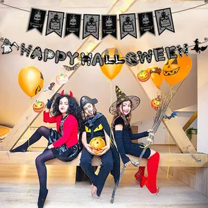 Children celebrating with Halloween banner decorations in a festive room setup