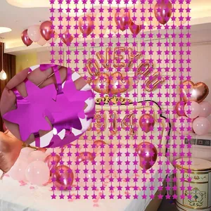 Magenta star-shaped foil fringe curtain detail and party room decoration setup view