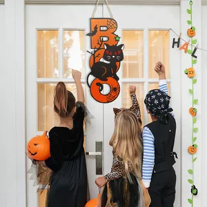 Halloween wooden BOO sign on door with kids in costumes trick-or-treating scene