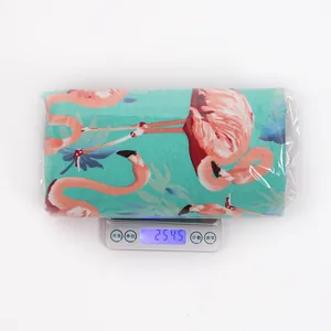 Flamingo print fabric table runner being weighed on a digital scale, showing 254.5g.