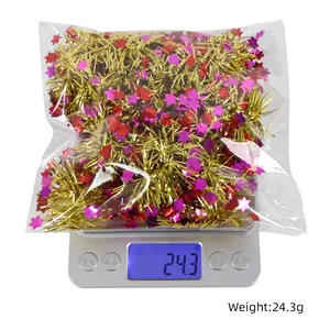 Detail view showing weight of star tinsel ribbon Christmas decoration at 24.3g