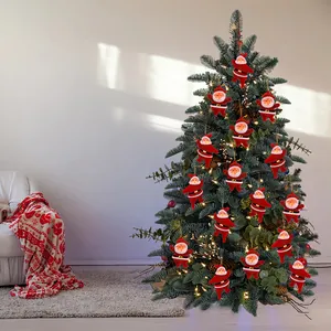 Festive red flocked Santa Claus ornaments hanging on a lighted Christmas tree in a cozy room