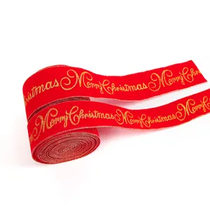 Detailed view of red velvet Christmas ribbon with gold embossed Merry Christmas text
