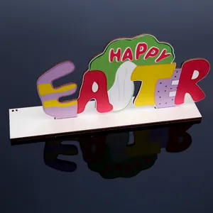 Close-up of colorful Happy Easter wooden ornament on a black reflective surface