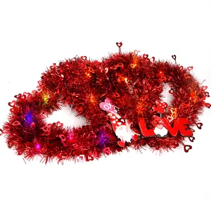 Detail of heart-shaped Valentine tinsel wreath with LED lights and festive gnome decoration
