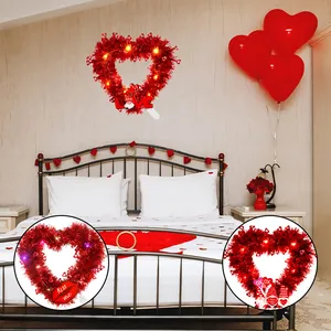 Detail view showing different designs of Valentine's Day heart wreaths with bright LED lights.