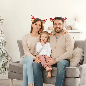 Family members wearing festive Christmas reindeer antler headbands with bells and bows