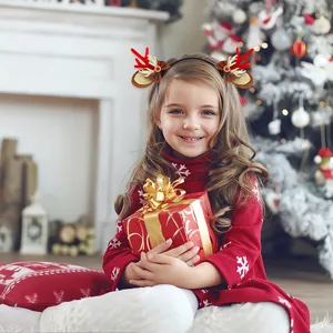 Little girl wearing Christmas reindeer antler headband with bells and bow