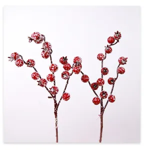 Close-up of artificial red berries with snow effect for Christmas DIY crafts decoration