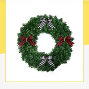 Close-up of red and white buffalo plaid decorative bows on a green Christmas wreath