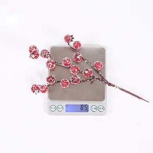 Detailed view showing the weight of a single frosted artificial berry sprig at 8.5g.