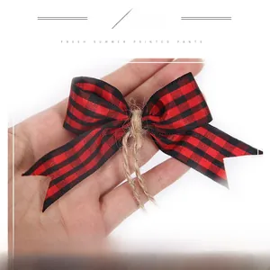Close-up of red and black checkered Christmas bow with twine tie for DIY crafts