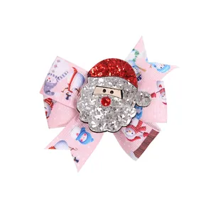 Festive Christmas bow hair clip featuring a glittery Santa Claus and cute snowman patterns