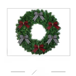 Detailed view of red and black checkered bows on a green Christmas wreath