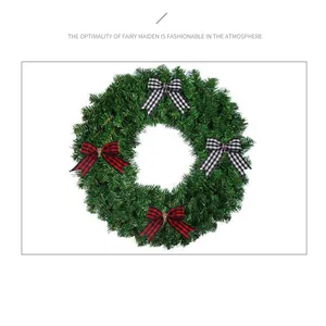 Close-up of red and black checkered bows on a green Christmas wreath decoration