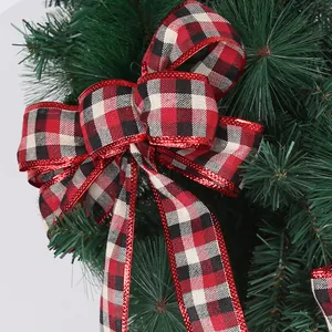Large red and black buffalo plaid Christmas tree bow with glitter edges for festive decor