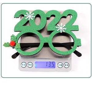 Detailed view of lightweight green 2022 Christmas party glasses on a digital scale