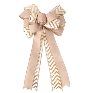 Detail view of a large gold chevron and burlap Christmas tree topper bow