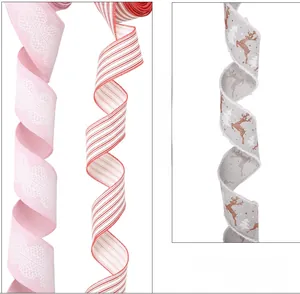 Close-up detail of Christmas linen ribbons with lace, stripes, and reindeer patterns.