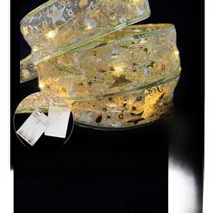 Close-up detail of 4m Christmas gold ribbon LED lights with battery compartment