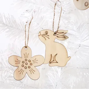 Detailed macro view of laser-cut wooden rabbit and flower ornaments on a white tree