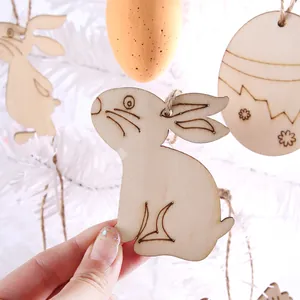 Close-up of a DIY wooden Easter rabbit hanging ornament on white festive tree