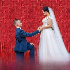 Detail view of 2m red heart tinsel curtain backdrop for romantic wedding decorations