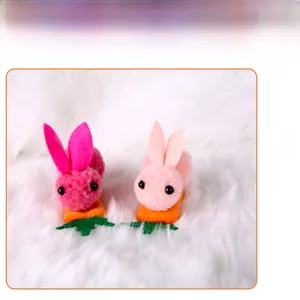 Detail view of plush rabbit and carrot Easter hair clips on white fur background.