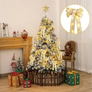 Detailed view of glowing gold-edged Christmas bows with warm LED lights on a decorated tree