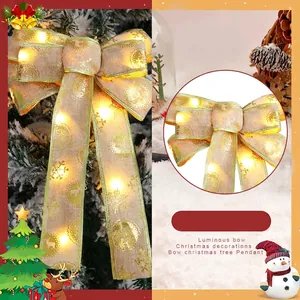 Elegant luminous Christmas tree bow with gold edges and warm internal LED lights