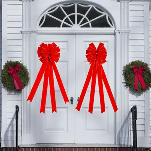 Large red velvet Christmas bows with gold edges for festive front door holiday decoration