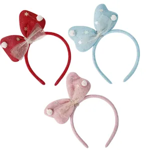 Set of three Christmas bow headbands with snowflakes and pom-poms in red, blue, and pink