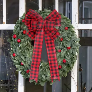 Christmas wreath with large red black buffalo plaid bow and LED lights for holiday decor
