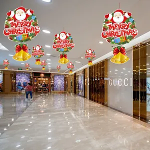 Indoor commercial scene showing colorful Christmas hanging decorations with Santa and bells