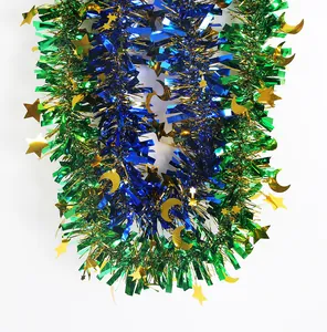Detailed view of festive blue and green tinsel garland with gold stars and moons