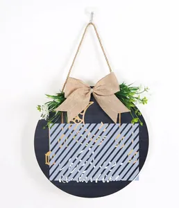 Detail of round Ramadan wooden sign with burlap bow and artificial greenery