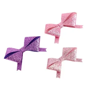 Set mit drei glitzernden Mini-Schleifen in Lila und Pink für DIY-Geschenkbox-Dekoration