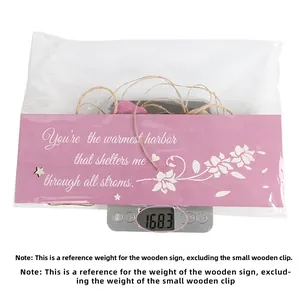 Digital scale showing the weight of a wooden Mother's Day photo hanging plaque
