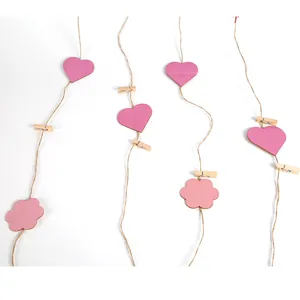 Detail view of Mother's Day wooden heart clips and pink flower tags with twine.